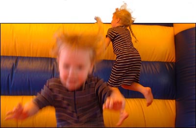 Two girls jumping in a jumping castle...